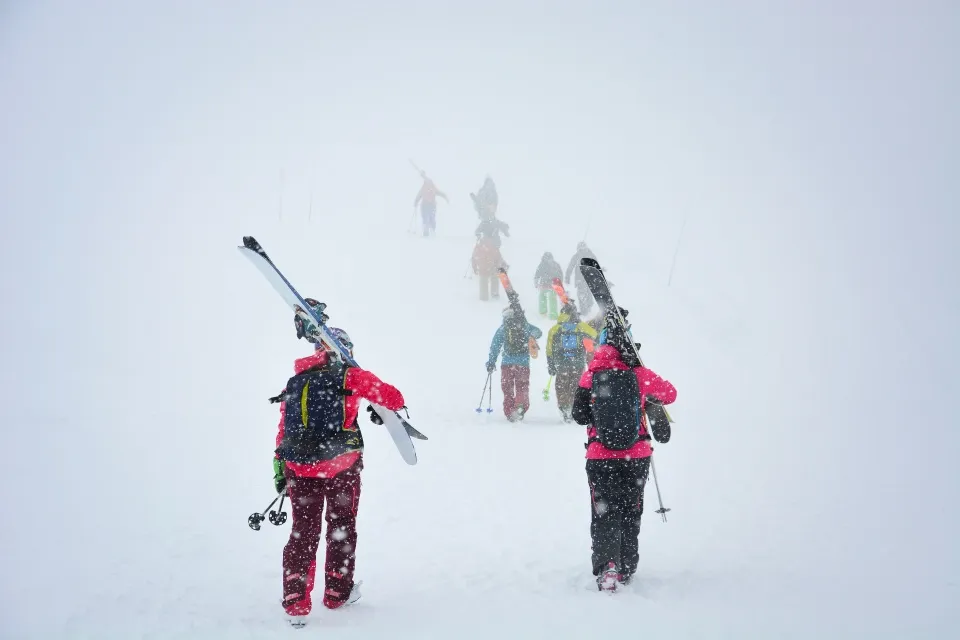 Skiers carry skis and equipments for skiing on Mount Asahidake